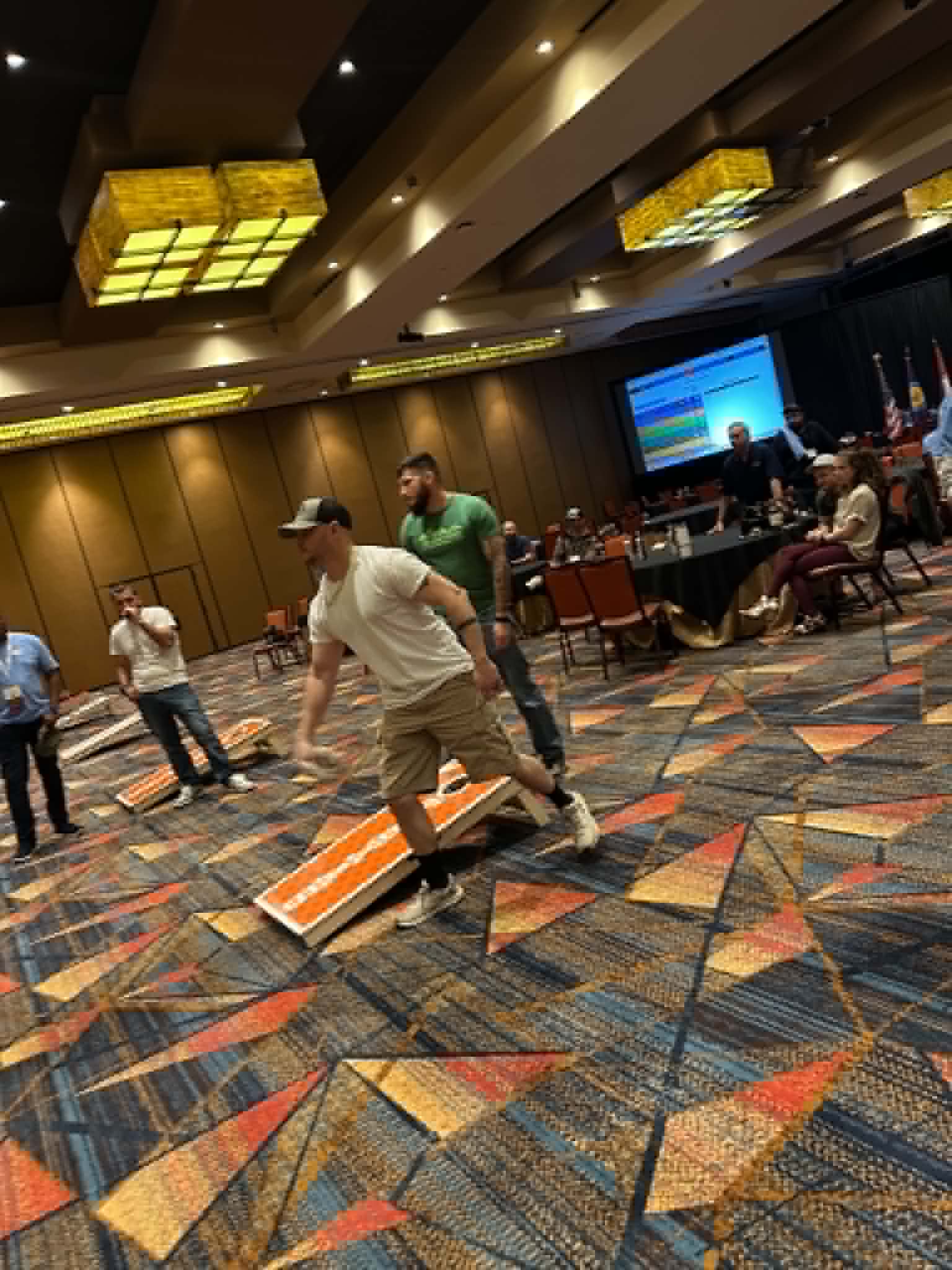 An evening cornhole game during the 2026 conference